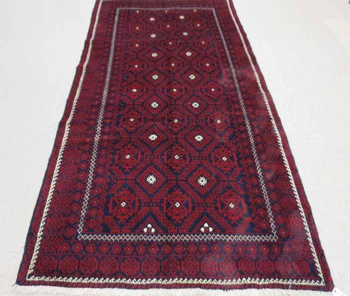 Appraisal: HAND KNOTTED ORIENTAL CARPET Persian Belouch tribal overall geometric design