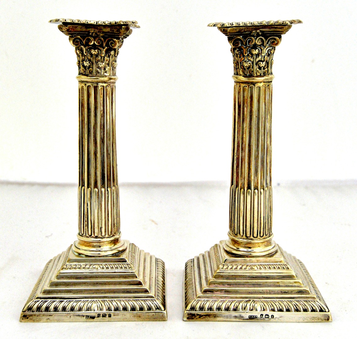 Appraisal: A pair of silver candlesticks each formed as a Corinthian