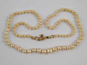 Appraisal: A graduated cultured pearl necklace approx cm long largest pearl