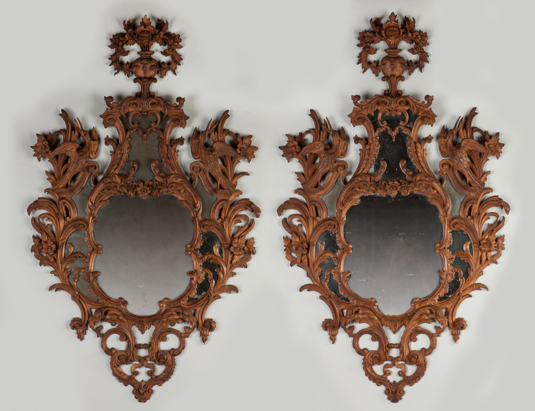 Appraisal: A Pair of Carved Continental Mirrors With carved phoenix birds