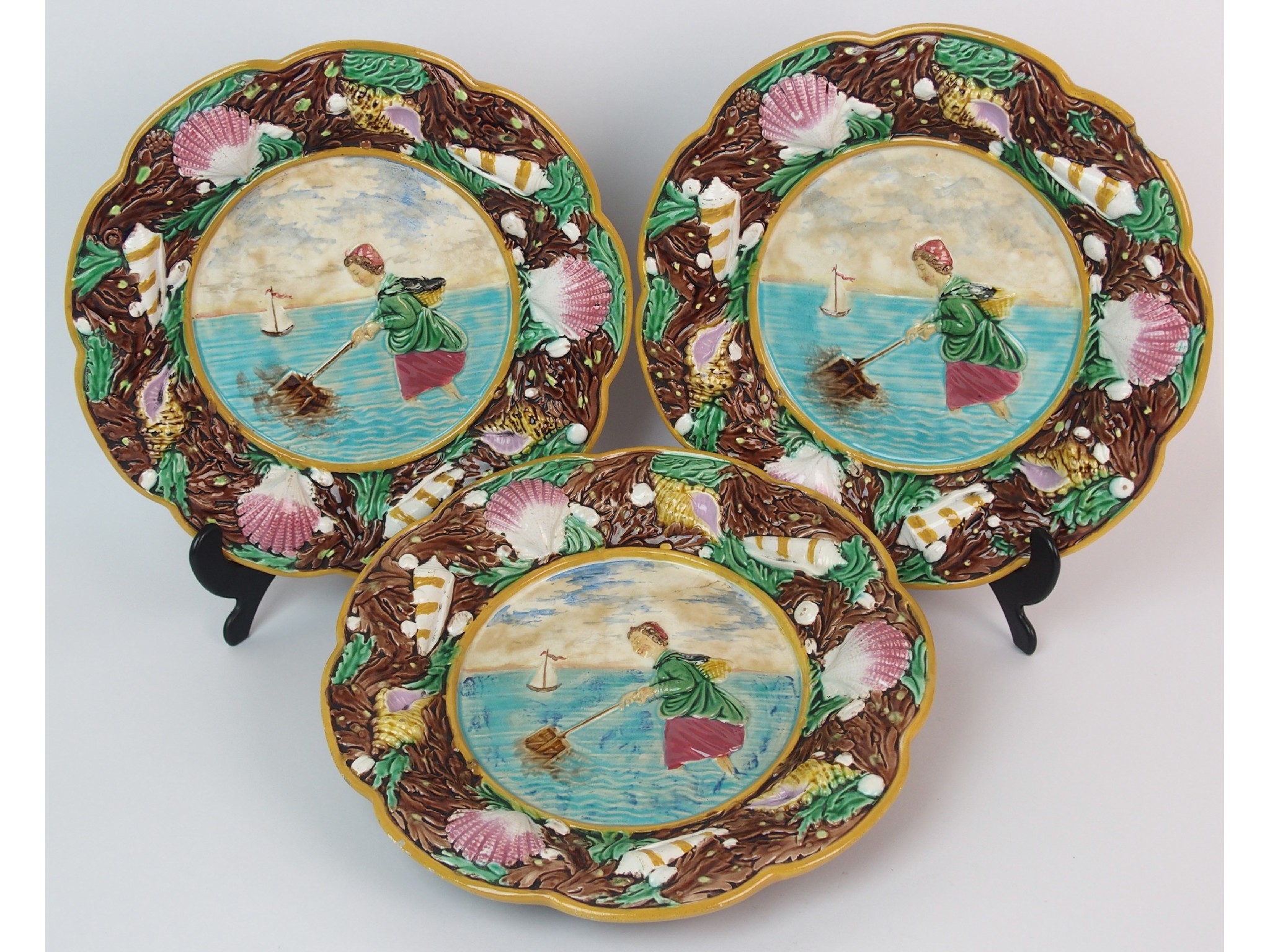 Appraisal: Three George Jones majolica relief moulded plateseach with a fisherwoman