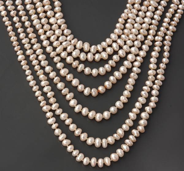 Appraisal: A cultured rice pearl seven strand necklace with a k