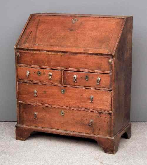 Appraisal: An early th Century oak bureau the slope enclosing fitted