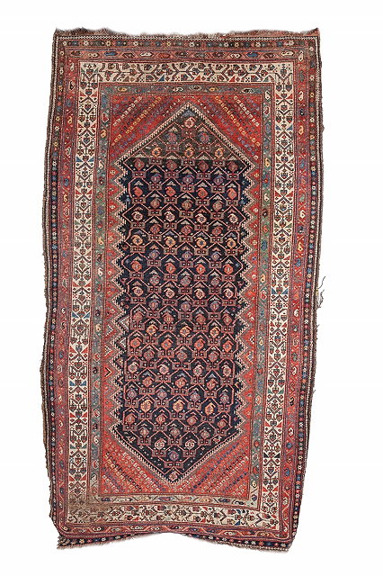 Appraisal: A PERSIAN LURI RUG the central blue ground panel decorated