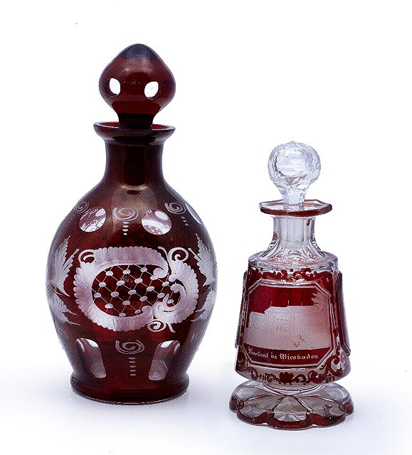 Appraisal: A Bohemian ruby glass decanter th centuryengraved with rural scenes