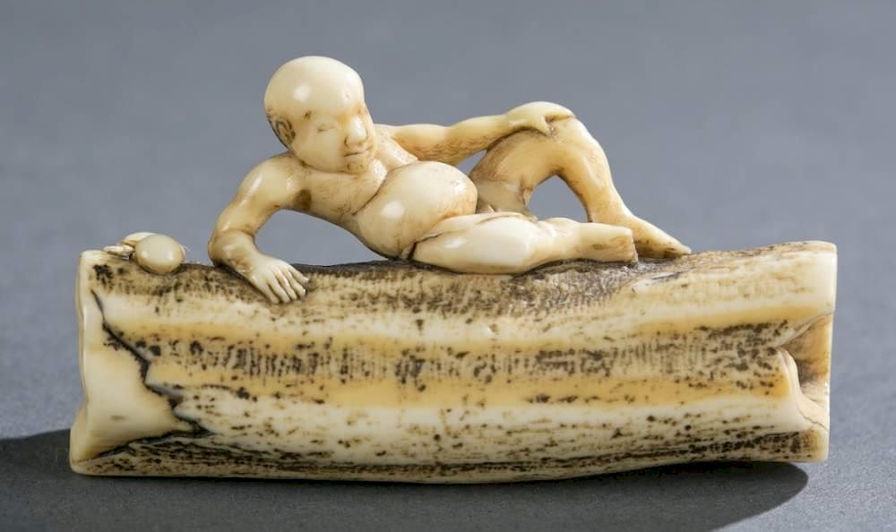 Appraisal: Japanese stag antler netsuke of reclining on log A Japanese