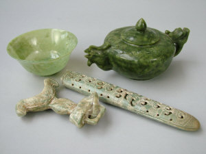 Appraisal: A Chinese spinach green jade teapot with carved handle and