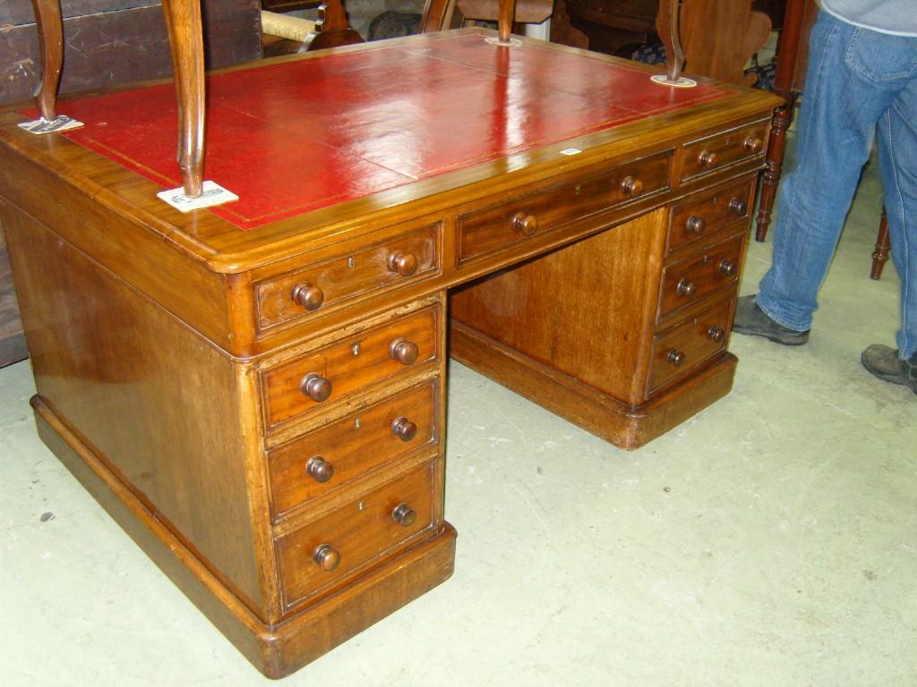 Appraisal: A Victorian mahogany kneehole partners desk fitted with the usual