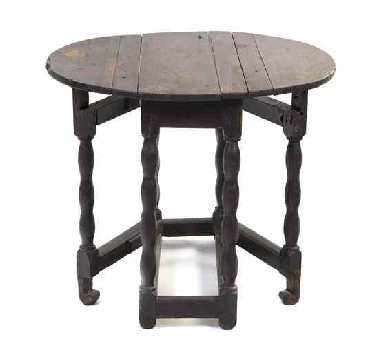 Appraisal: A Continental Oak Drop-Leaf Table having a rectangular top with