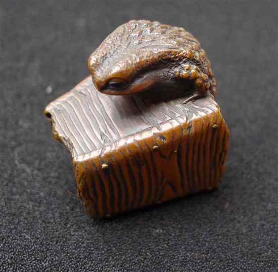 Appraisal: A Meiji period hardwood netsuke carved as a toad climbing