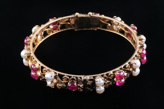 Appraisal: K YELLOW GOLD RUBY AND PEARL BANGLE BRACELET Openwork bangle