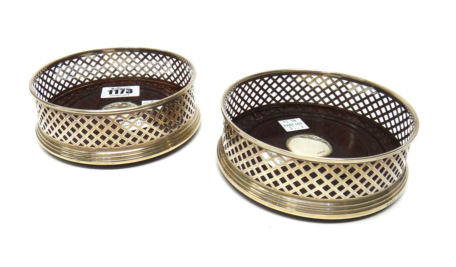 Appraisal: A pair of silver mounted circular bottle coasters with pierced