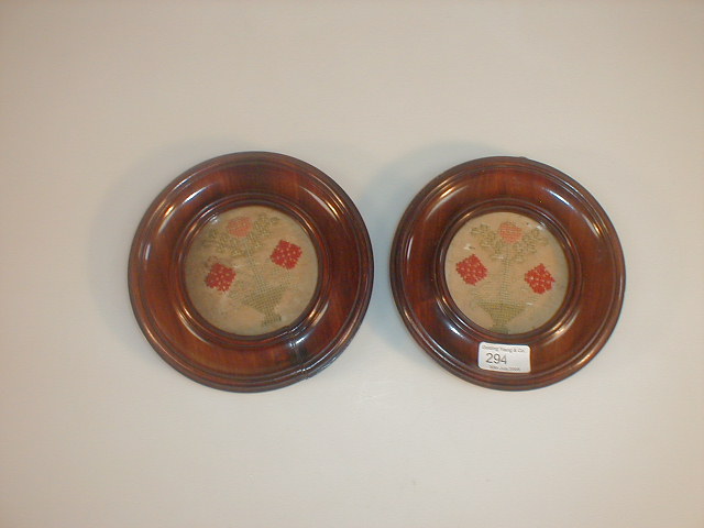 Appraisal: Two circular mahogany framed woolwork pictures of flowers in a