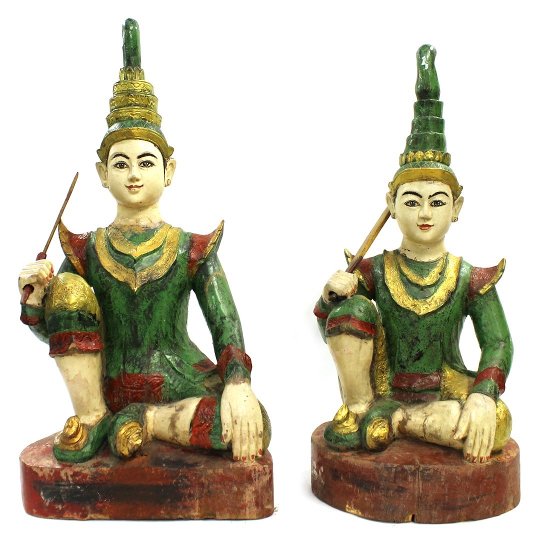 Appraisal: Two th century Thai painted wood figures of youths seated