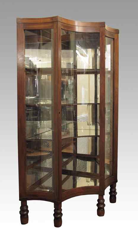 Appraisal: A UNIQUE FORM CORNER DISPLAY CABINET Curved and angled glass