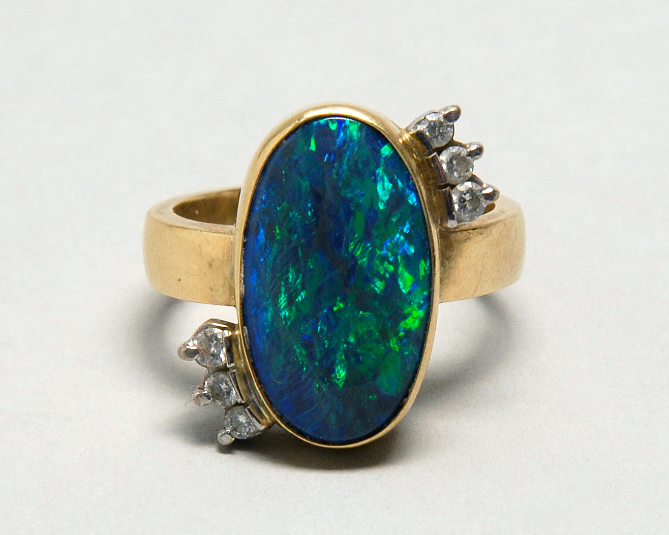 Appraisal: KT YELLOW GOLD OPAL AND DIAMOND COCKTAIL RING Oval bezel-mounted