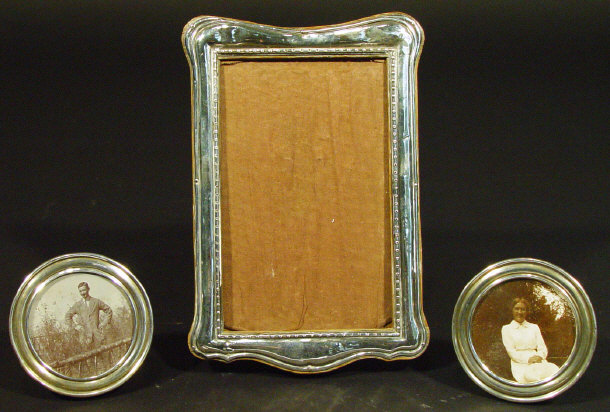 Appraisal: Pair of circular silver photo frames and a rectangular silver