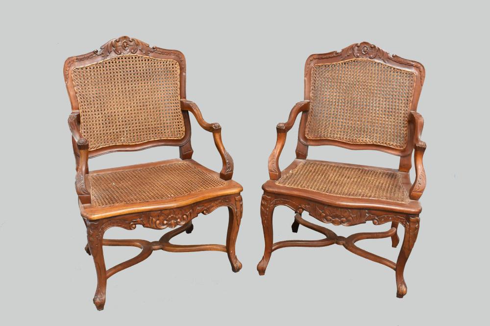 Appraisal: PAIR OF EARLY LOUIS XV STYLE CANED WALNUT ARMCHAIRSThe shaped