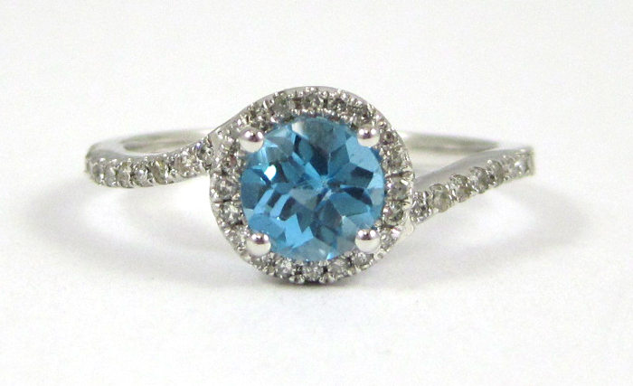 Appraisal: BLUE TOPAZ AND FOURTEEN KARAT WHITE GOLD RING with round-cut