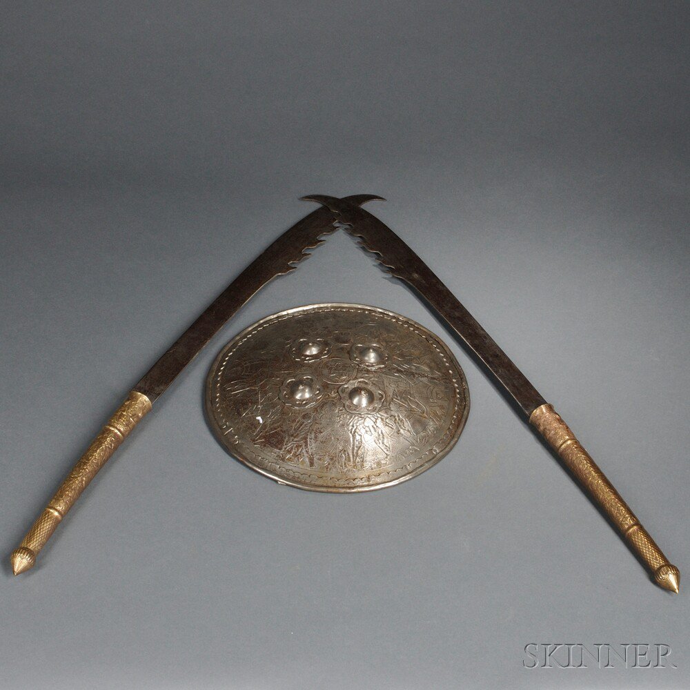 Appraisal: Shield and Two Swords c th century brass hilted swords