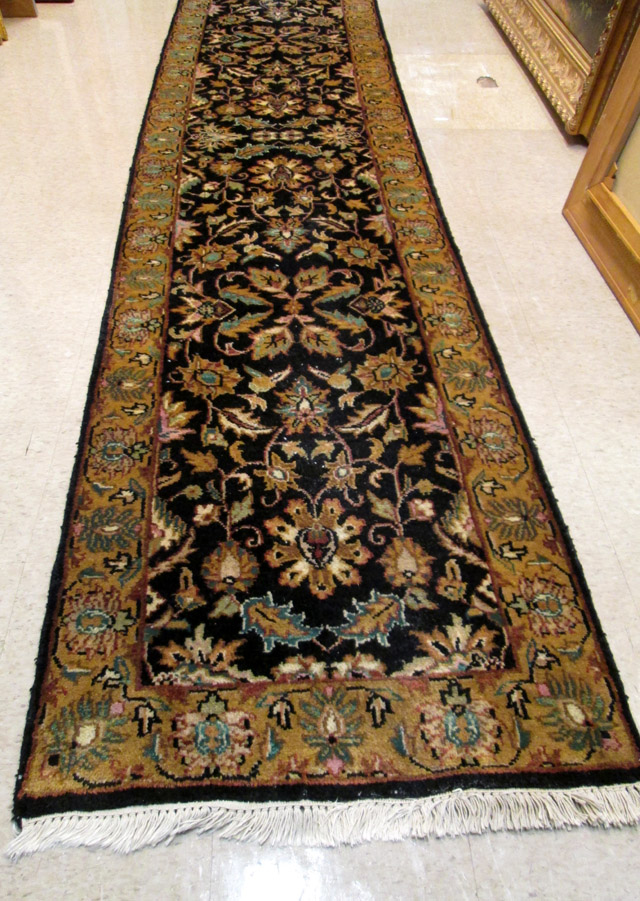 Appraisal: HAND KNOTTED ORIENTAL LONG RUG Indo-Persian overall foliate design on