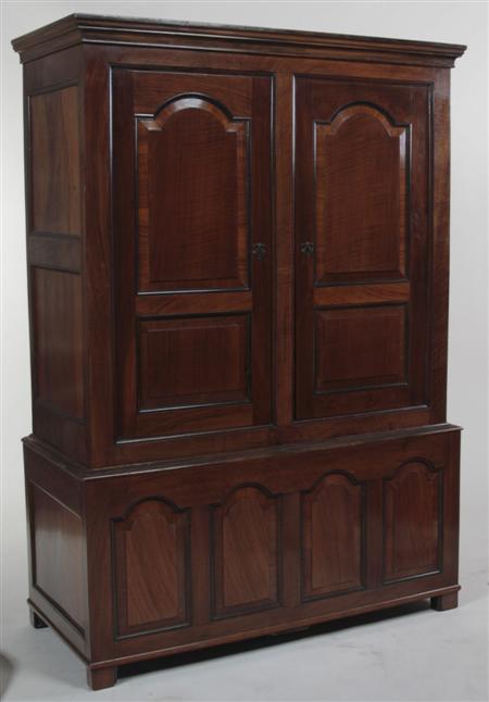 Appraisal: A walnut hall wardrobe the projected moulded cornice over two