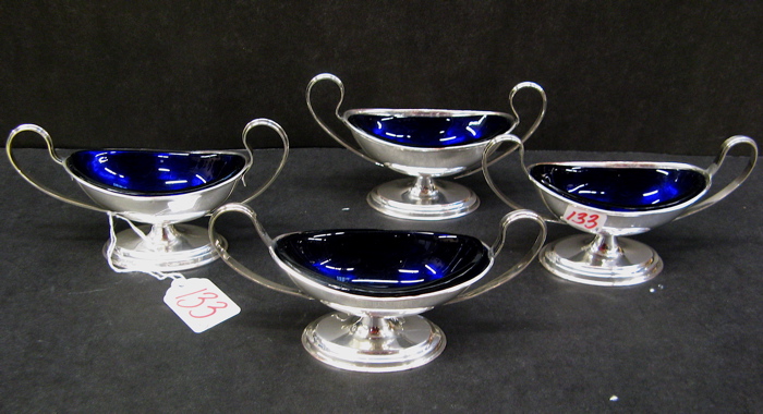 Appraisal: FOUR SILVER PLATED PEDESTAL SALTS oval with cobalt blue glass