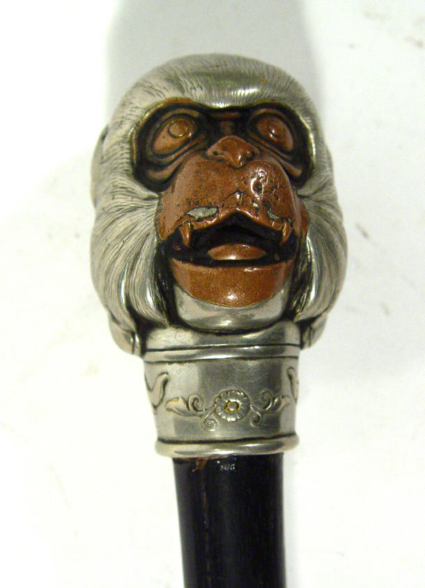 Appraisal: Oriental white metal and bronze handle walking cane the grip