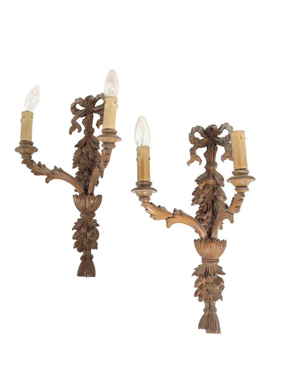 Appraisal: A pair of carved and stained wood twin branch wall