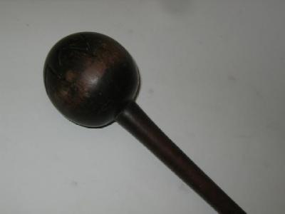 Appraisal: A HARDWOOD KNOBKERRIE the polished sphere with carved zigzag banding