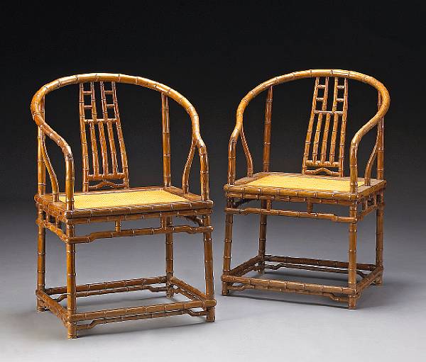 Appraisal: A pair of wood chairs carved in a 'faux bamboo'