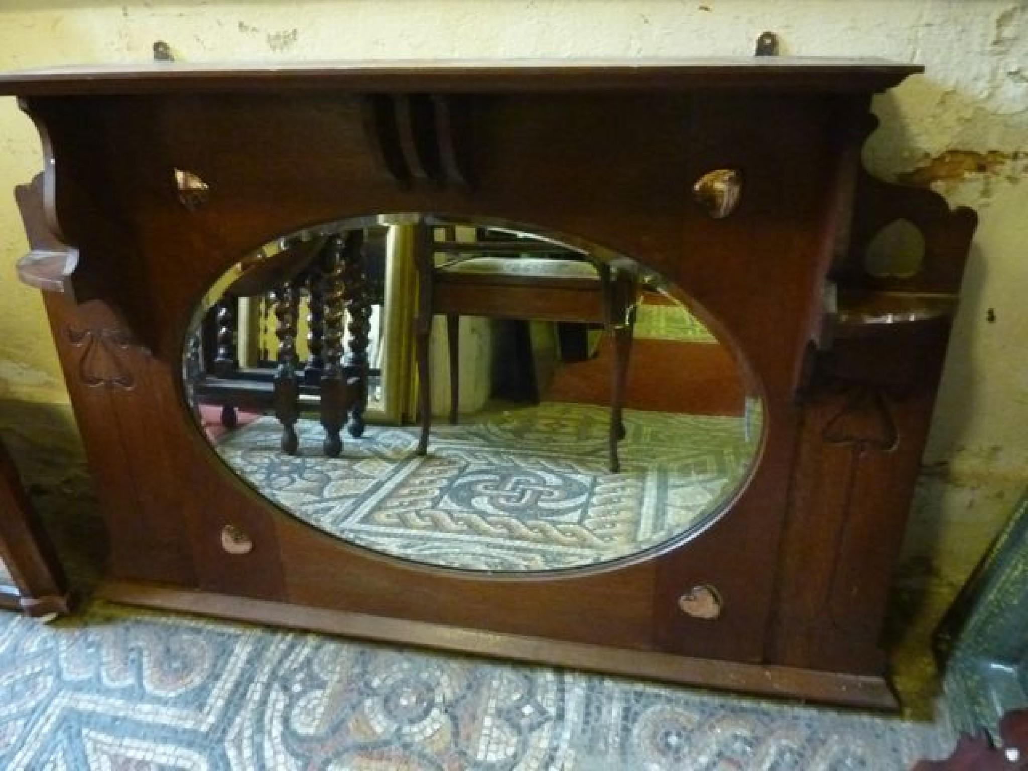 Appraisal: An Arts Crafts style oak overmantle mirror with incised carved