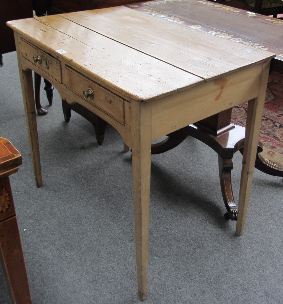 Appraisal: An early th century pine two door side table on