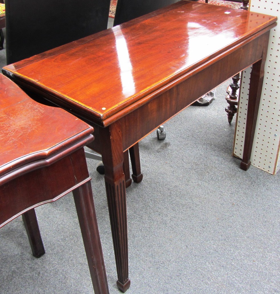 Appraisal: An th century mahogany tea table with fold-out rectangular top