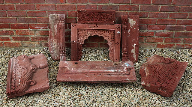 Appraisal: A GROUP OF INDIAN RED SANDSTONE CARVED ARCHITECTURAL ELEMENTS possibly