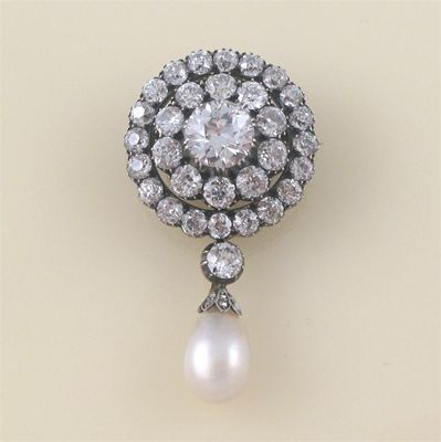 Appraisal: A Victorian diamond target brooch with pearl drop the centre