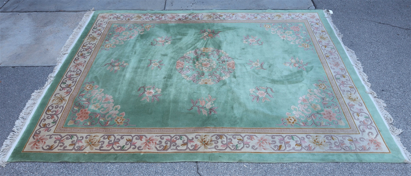 Appraisal: Large Chinese wool rug green background with floral motifs minor