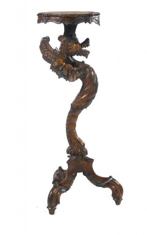 Appraisal: AN ITALIAN CARVED WALNUT TORCH RE the serpentine top with