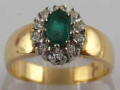 Appraisal: A yellow metal tests carat gold emerald and diamond ring