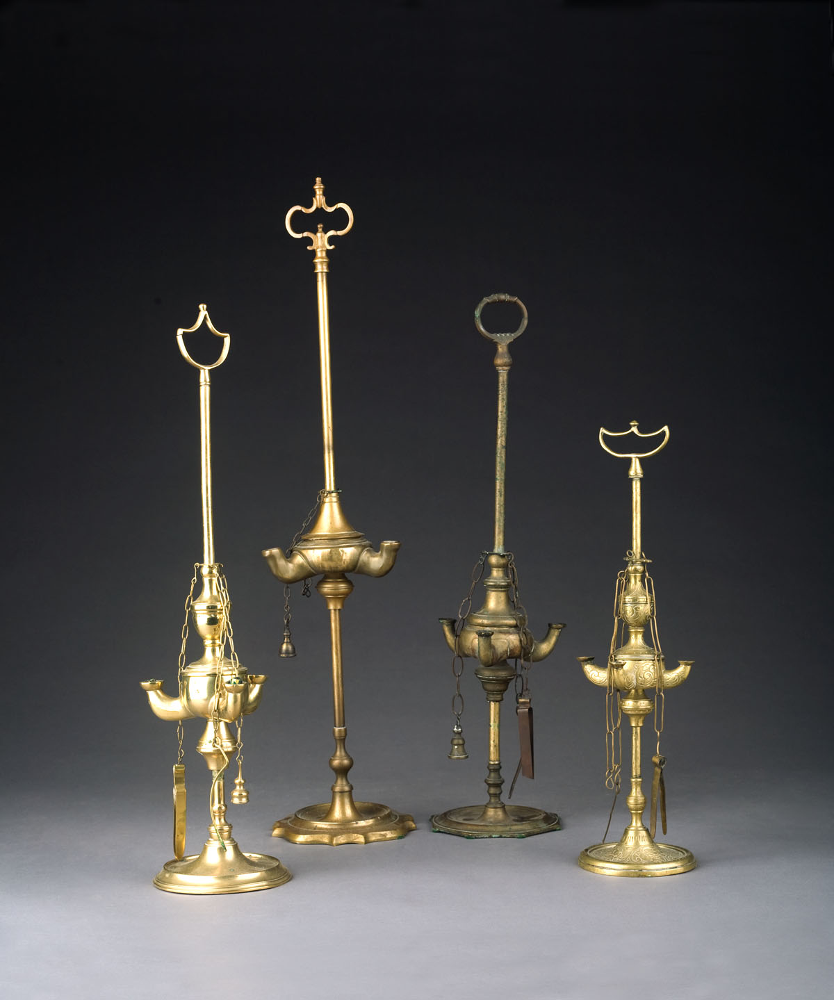 Appraisal: FOUR BRASS ROMAN STYLE LAMPS AFTER THE ANTIQUE Height of