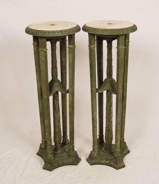 Appraisal: PAIR OF BRONZE WITH MARBLE TOP PEDESTAL STANDS Long fluted