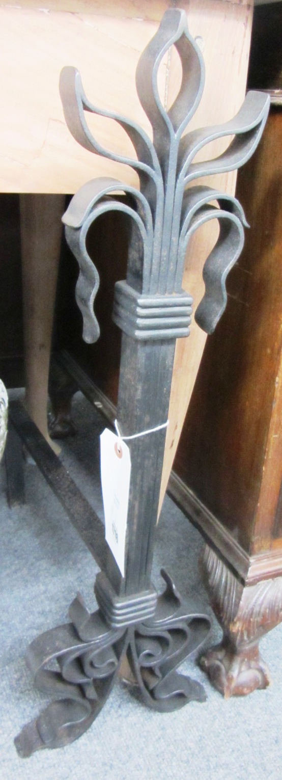 Appraisal: A pair of wrought iron andirons in the Arts and