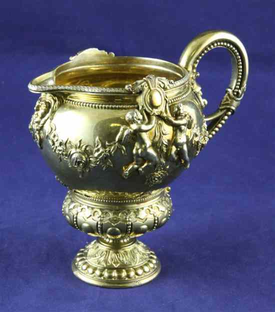 Appraisal: An ornate Victorian silver gilt cream jug by George Ivory