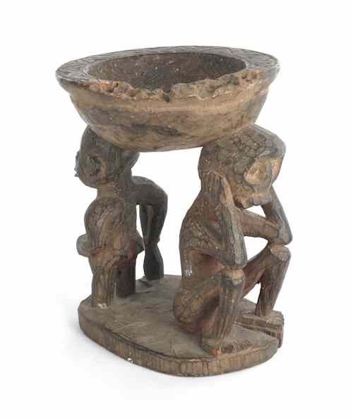 Appraisal: Carved African bowl supported by two human figures