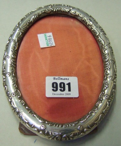 Appraisal: A silver mounted oval photograph frame with floral and scroll