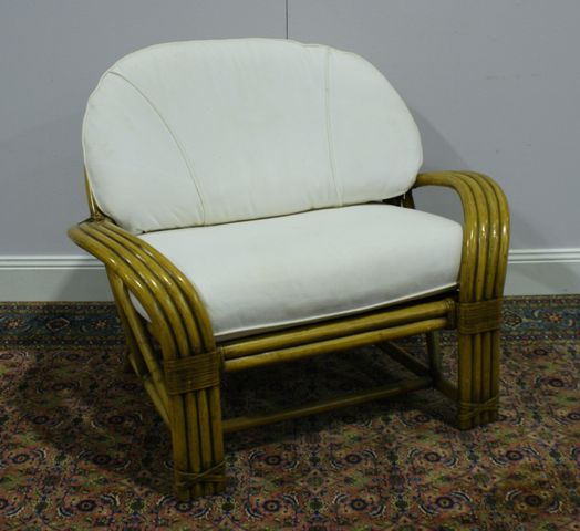 Appraisal: A British colonial style rattan patio chair with loose fitted