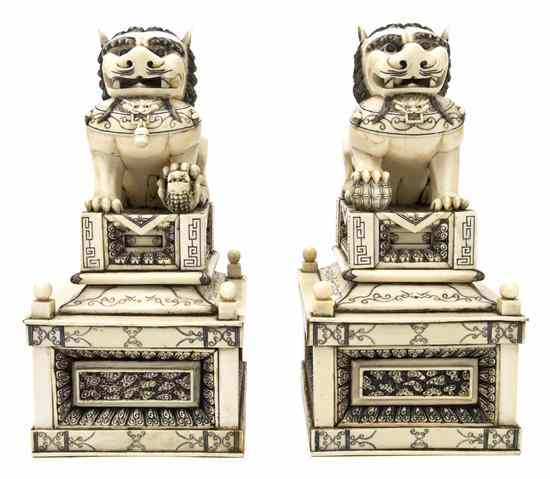 Appraisal: A Pair of Carved Ivory Fu Dogs the animals depicted