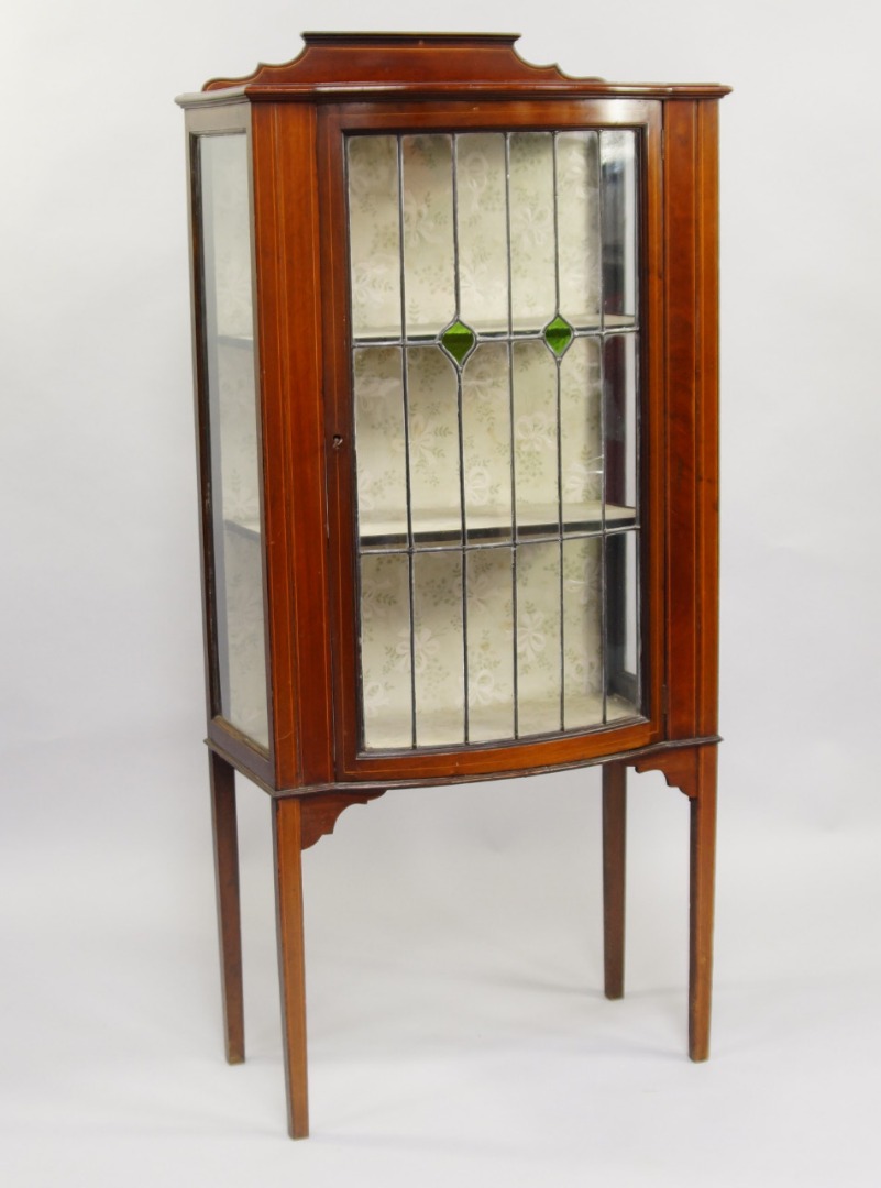 Appraisal: An Edwardian mahogany bow fronted display cabinet with boxwood inlay