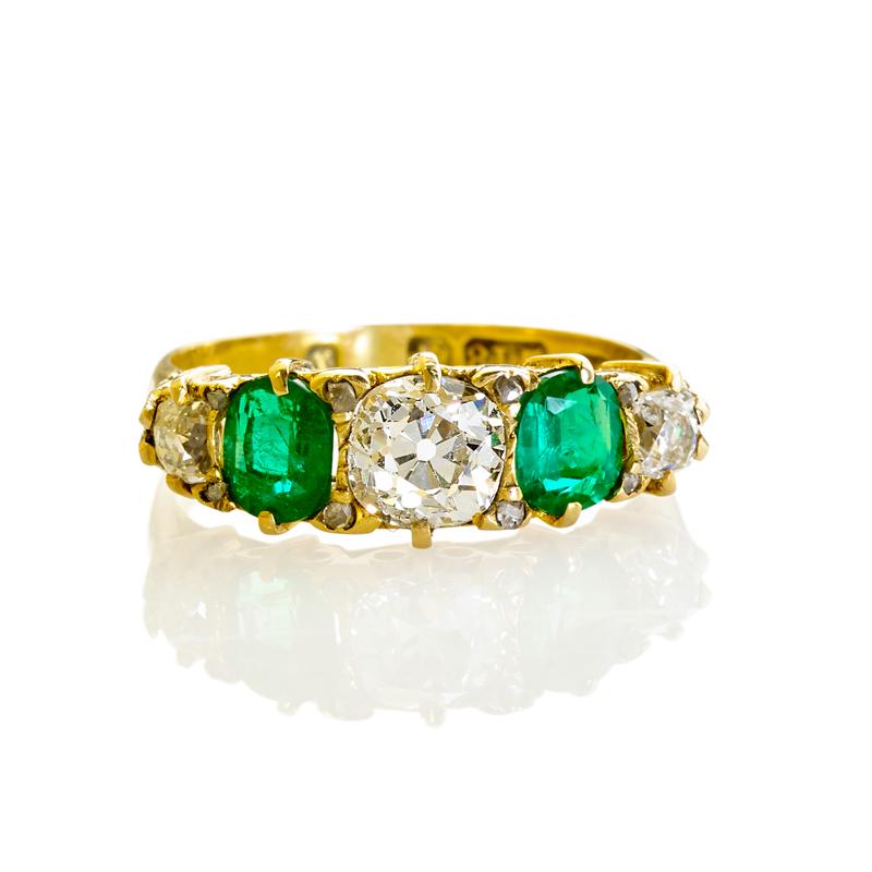 Appraisal: ENGLISH EMERALD AND DIAMOND FIVE-STONE RING Three OMC diamonds approx