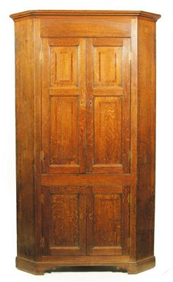 Appraisal: An early th century oak standing corner cupboard the mahogany